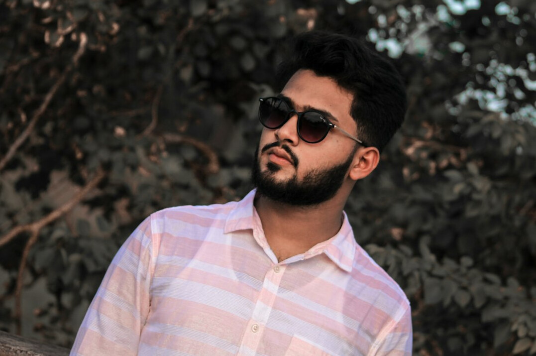 Portrait of a bearded man with glasses in a casual shirt