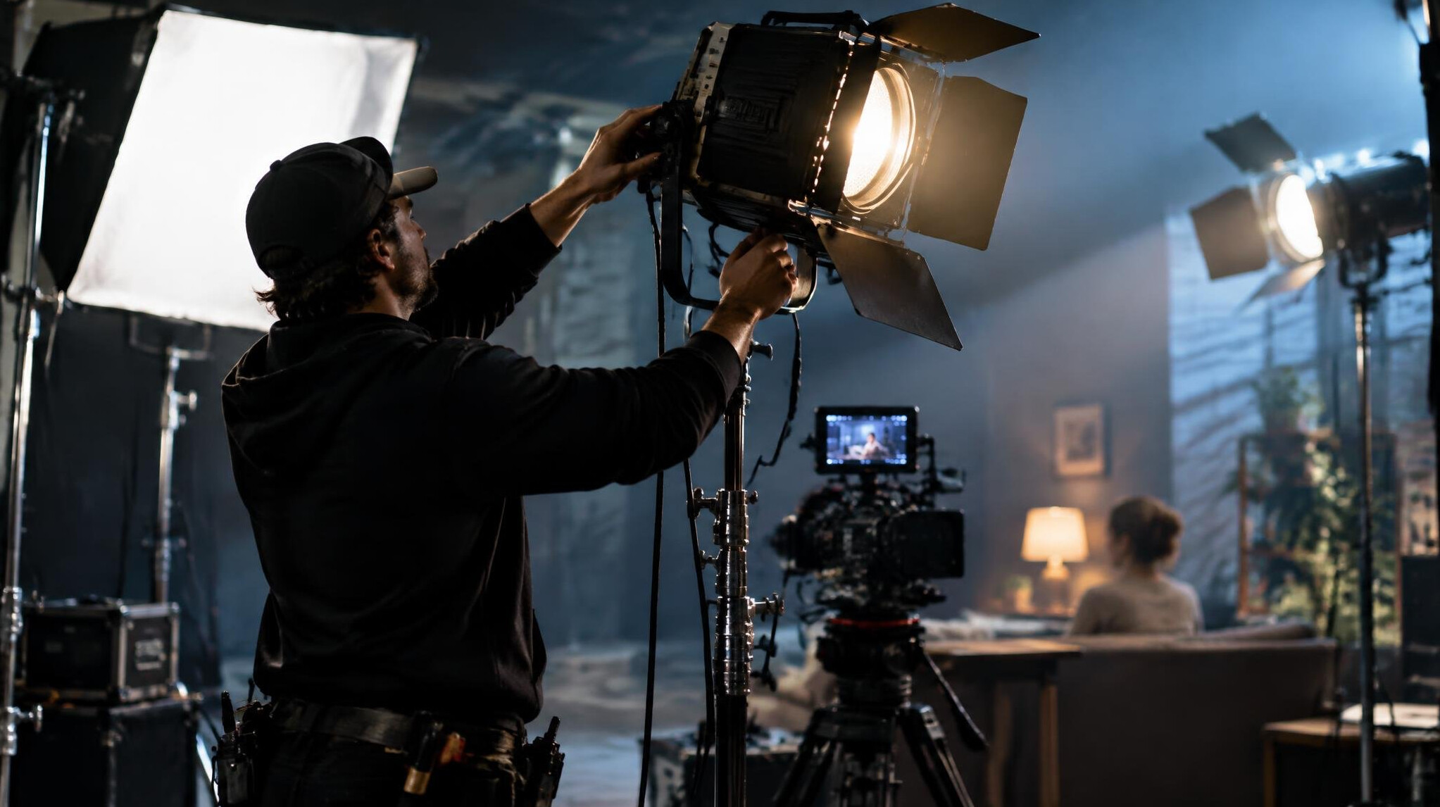 cinematographer adjusting lights